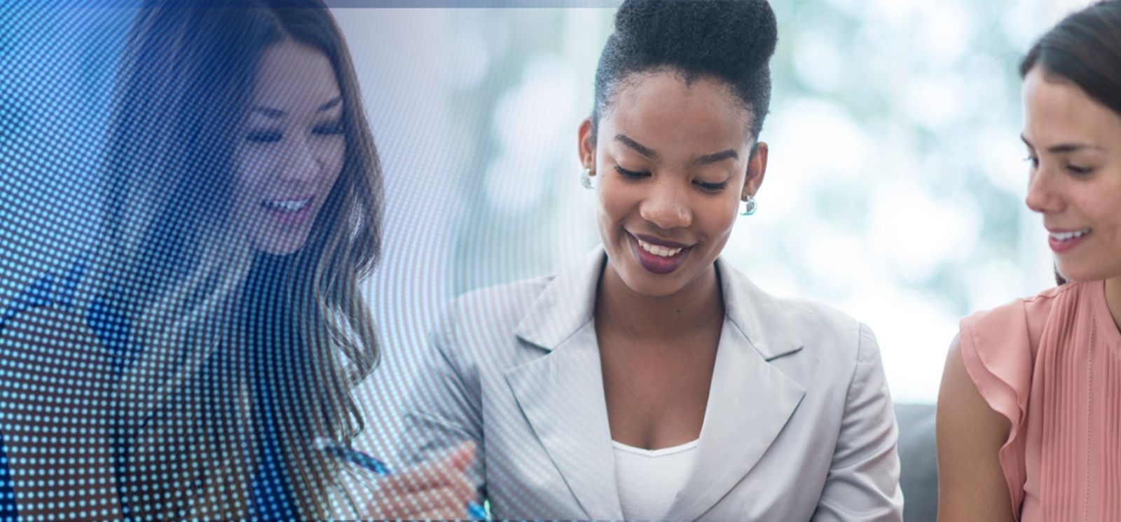 Three women smiling and talking with blue mesh overlay
