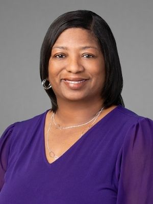 Woman in a purple shirt smiling